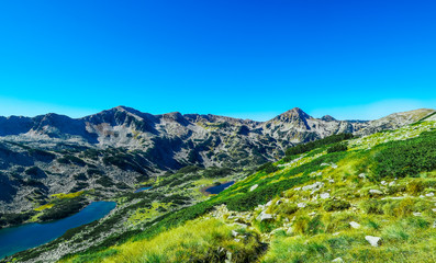 Naklejka na ściany i meble High mountain lake. Alpine nature, summer landscape backdrop.