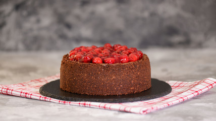 Delicious Homemade Chocolate Cheesecake Decorated With Cherry Sauce.