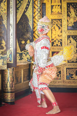 Thai pantomime dance scene Hanuman is standing with the weapons in ready position.
