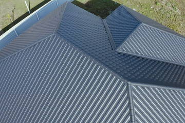 House with a gray metal roof. Corrugated metal roof and metal ro