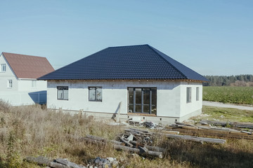 Fototapeta na wymiar House with a gray metal roof. Corrugated metal roof and metal ro