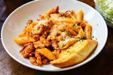 Chicken Pasta with Parmesan Cheese and Garlic Bread