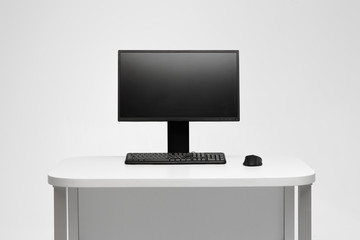 PC computer on desk. Designer wotkplace. Big monitor on the stand.