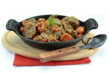beef and carrot cooked in a dish