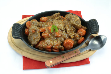 beef and carrot cooked in a dish