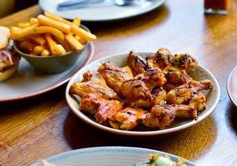 Grilled Chicken Wings & Chips Placed on Restaurant's Dining Table