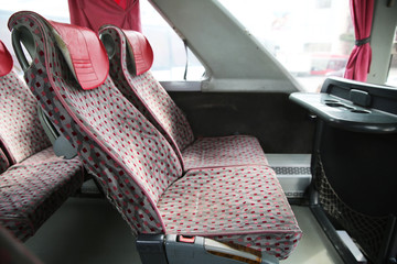 interior of new modern bus . bus seat Safety belts . Seating in the interior of the bus, transportation and comfortable travel . Open double interior of new modern red chairs bus . © Adil
