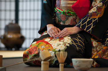 Japanese woman in traditional kimono, during the tea ceremony.