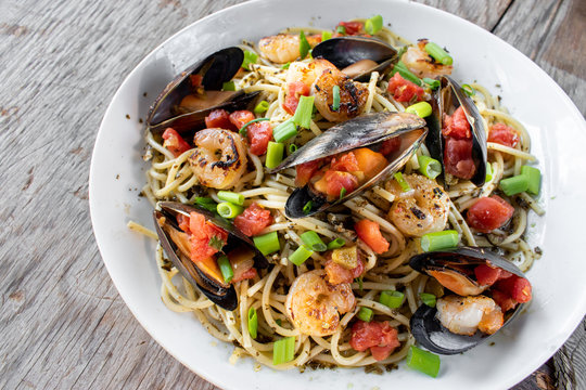 Mediterranean Seafood pasta dish of Mussels, fish, and shrimp flat lay