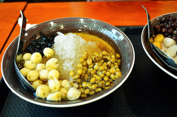 Chinese Sweet Tofu Bean Curd Soup with Soft Tofu, Mung Beans, Lotus Seeds and Ice. A Healthy Sweet Treat.