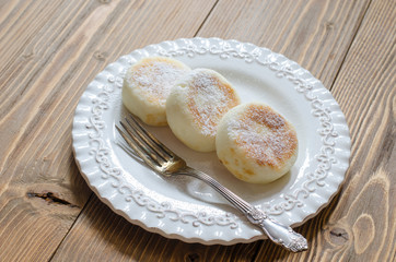 Cheesecakes on rice flour without eggs on a white plate