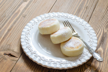 Cheesecakes on rice flour without eggs on a white plate