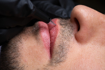 Male NU Lips. Young man closeup lips, male permanent make up, men's bristle.