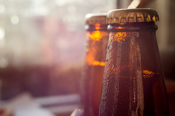 cold beer bottle in droplets of water of their refrigerator