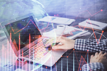 Double exposure of forex chart with man working on computer on background. Concept of market analysis.