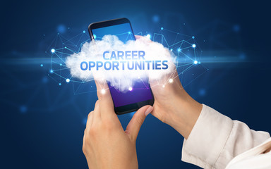 Female hand touching smartphone with CAREER OPPORTUNITIES inscription, cloud business concept
