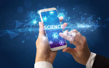 Female hand holding smartphone with SCIENCE inscription, modern technology concept