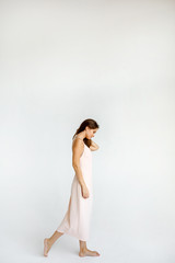 Fototapeta premium Full body young slim brunette woman on white background in studio