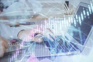 Multi exposure of stock market graph with man working on laptop on background. Concept of financial analysis.