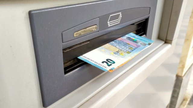 Man withdraw euro cash from an ATM machine