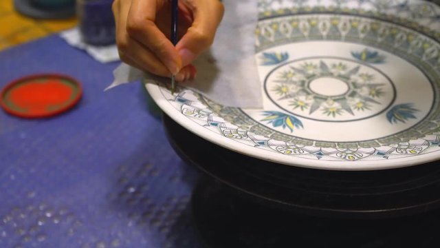 girl paints a plate in Turkish style, Painting Ceramic Plate,Turkish pottery painting, Turkish painted ceramics