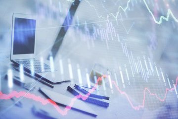 Forex graph hologram on table with computer background. Multi exposure. Concept of financial markets.