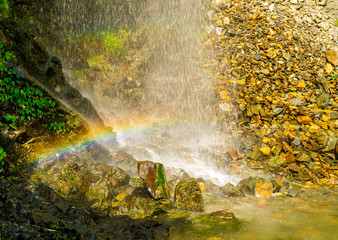 Fototapeta na wymiar A perennial roadside waterfall and a rainbow, Mussoorie, Uttarakhand, India
