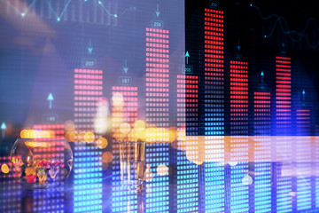 Obraz premium Financial graph colorful drawing and table with computer on background. Double exposure. Concept of international markets.