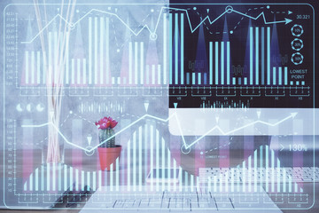 Financial chart drawing and table with computer on background. Multi exposure. Concept of...