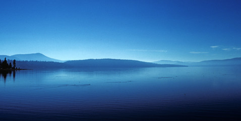 Tranquil Lake, blue sky, blue water. rolling hills