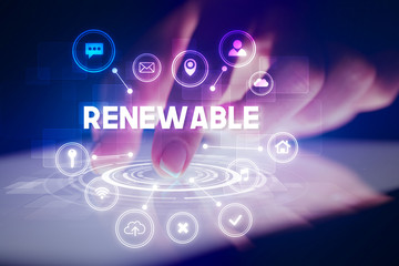 Finger touching tablet with web technology icons and RENEWABLE inscription, web technology concept