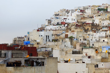 Fototapeta na wymiar View of the colorful old buildings of Tetouan Medina quarter in Northern Morocco. A medina is typically walled, with many narrow and maze-like streets and often contain historical houses and places.