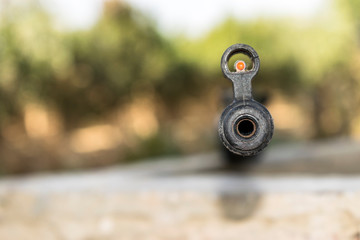 closeup of a riffle barrel and it's aim 
