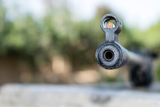 closeup of a riffle barrel and it's aim 