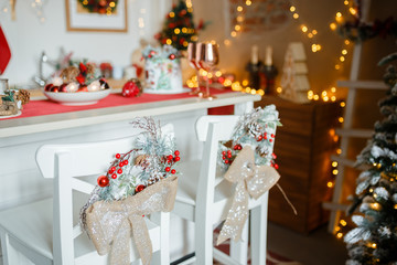 Beautiful holiday decorated kitchen with Christmas tree and bright lights , blur background