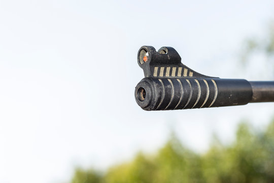 closeup of a riffle barrel and it's aim 