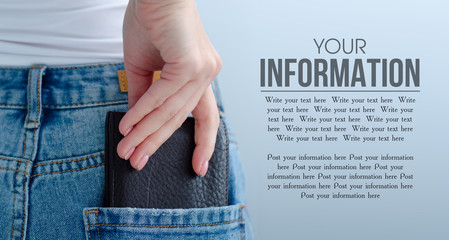 Woman wallet in jeans pocket on gray light background. Isolation, space for text