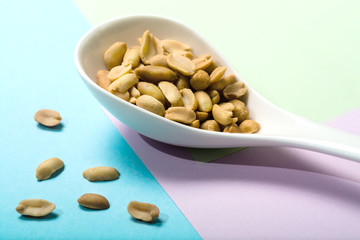 Peanut spoon on pastel background