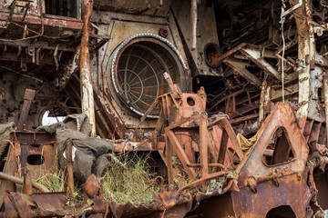 Internal parts of decommissioned marine ship that was cut and left on the shore.