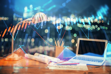 Financial chart drawing and table with computer on background. Double exposure. Concept of international markets.