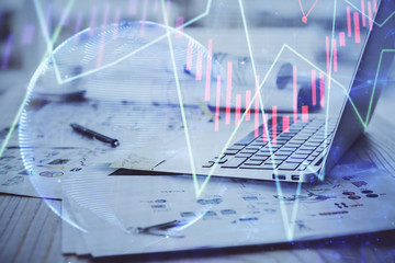 Fototapeta na wymiar Stock market graph on background with desk and personal computer. Double exposure. Concept of financial analysis.