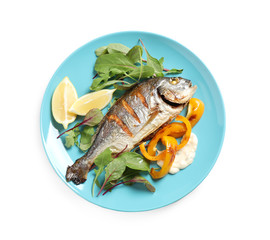 Delicious roasted fish with lemon and vegetables isolated on white, top view