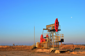 Oil drilling derricks at desert oilfield for fossil fuels output and crude oil production from the...