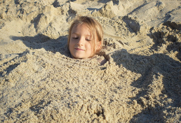 dziewczynka bawiąca się na plaży podczas letnich wakacji nad morzem  - obrazy, fototapety, plakaty