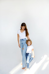Happy mother and daughter spend time together. Photo on a white background. Happy family concept