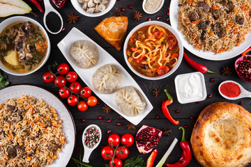 The concept of Eastern asian festive cuisine. Assorted Uzbek food set, pilaf, samsa, lagman, manti, shurpa restaurant concept Eastern arabic new year and Christmas dish from lamb served cookware.