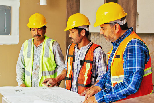 Construction team looking at blueprint