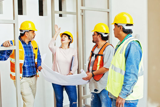 Construction team looking at blueprint