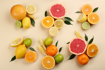 Flat lay composition with tangerines and different citrus fruits on beige background