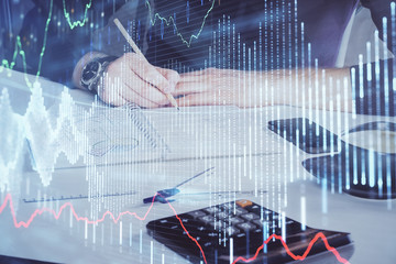 Double exposure of man doing analysis of stock market with forex graph.